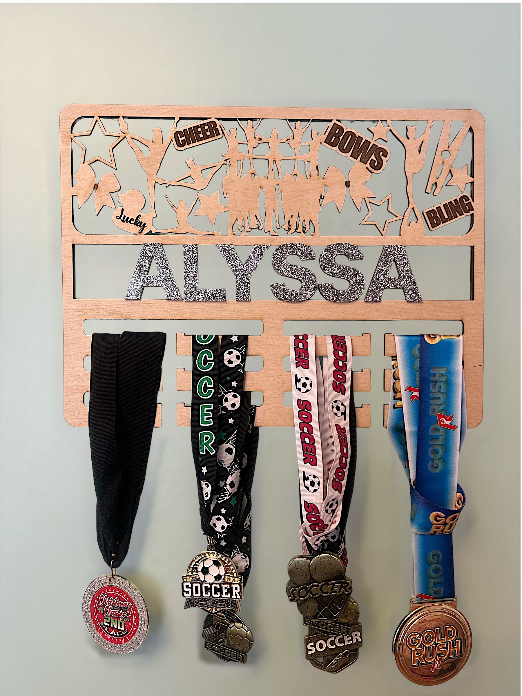 Unique Design – Glitter and Bow Accents on Competitive Cheer Medal Holder